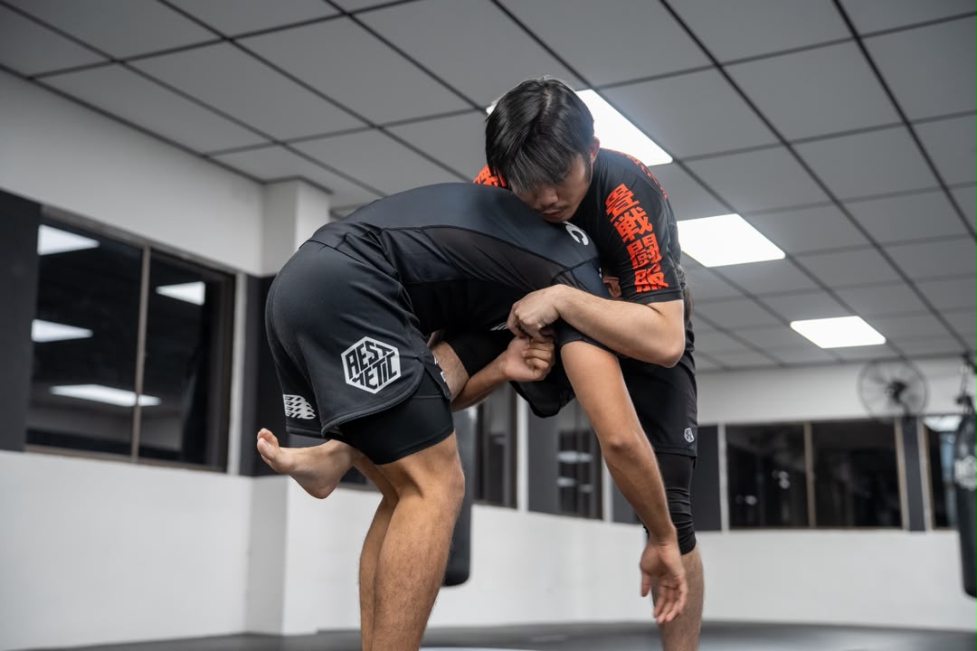 Two MMA students in a clinch during controlled sparring